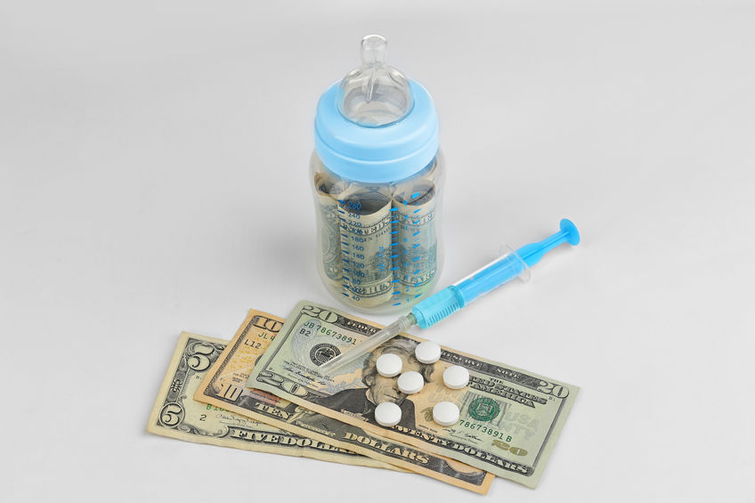 Enon UMC Pregnancy Resource Clinic baby bottle filled with paper money and $35 cash laying in front with several pills on top and a blue hypodermic syringe